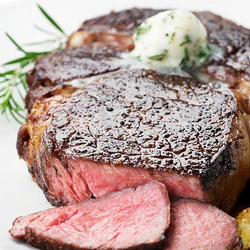 New York Steaks with Chive Butter and Merlot Sauce