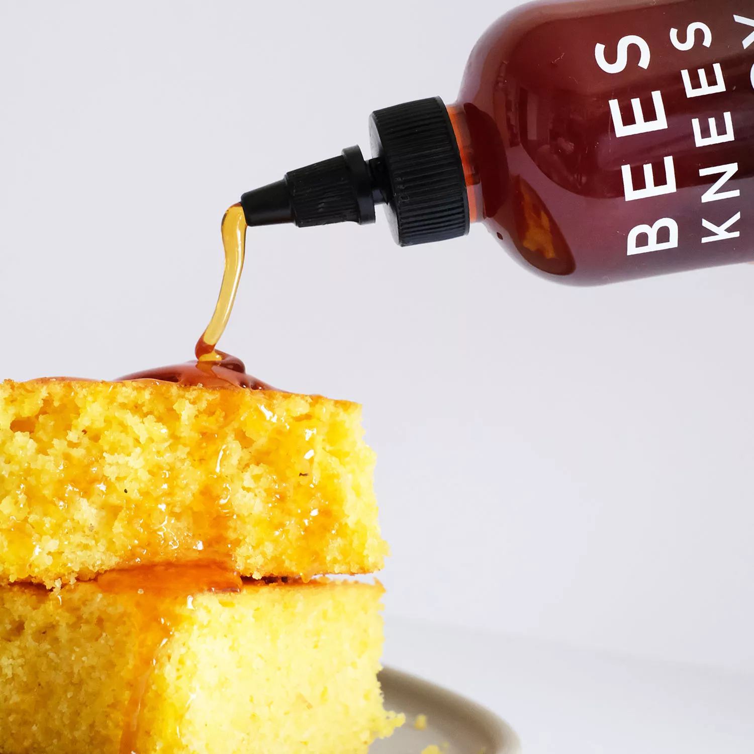 Honey Cake with Edible Bees on Top on a Checkered Red Towel