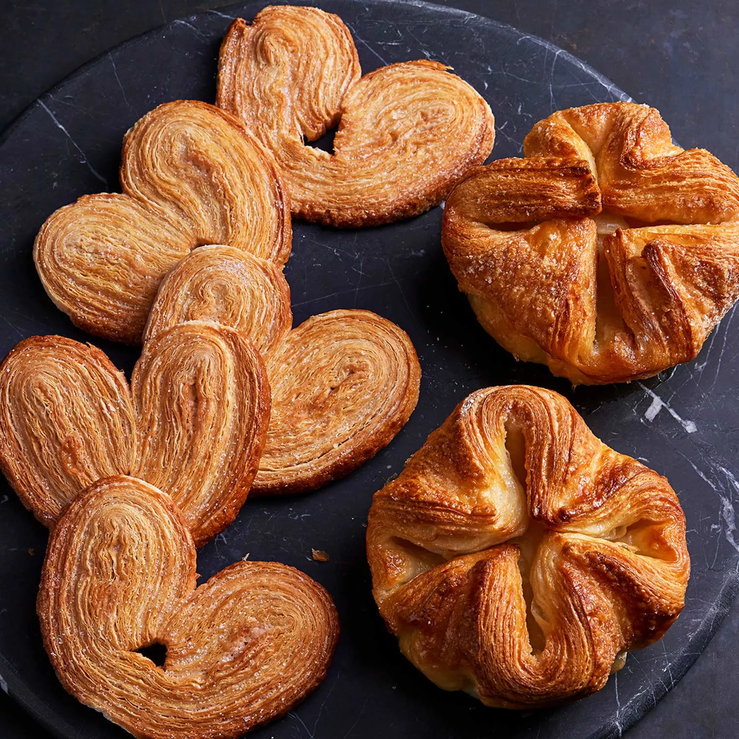 https://assets.surlatable.com/m/5dda0ffa85b25da7/72_dpi_webp-CFA-7528946_TheFrenchPastryShop_Palmiers-KouignAmann