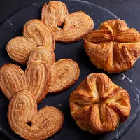 https://assets.surlatable.com/m/5dda0ffa85b25da7/72_dpi_webp_small-CFA-7528946_TheFrenchPastryShop_Palmiers-KouignAmann