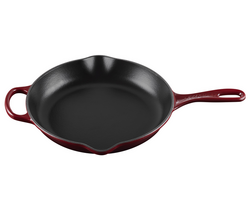 Le Creuset Signature Cast-Iron Skillet, 10.25" I really like this dark interior finished pan sears steaks on the stove nicely
