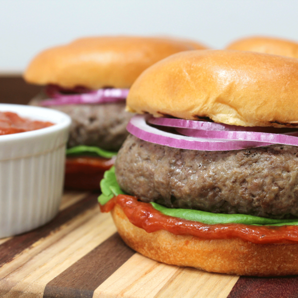 Angus Beef Burgers with Chipotle Ketchup, Spicy Onions and Marinated Tomato Salad
